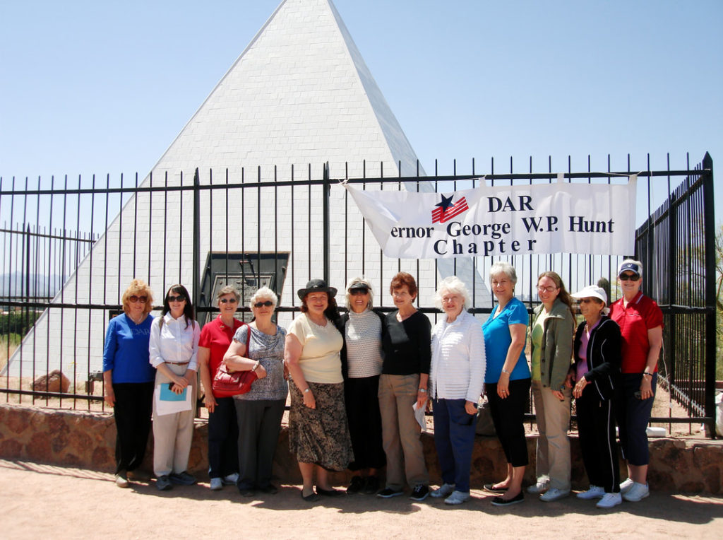 This photo shows twelve chapter members standing in front of the Tomb and their chapter banner.